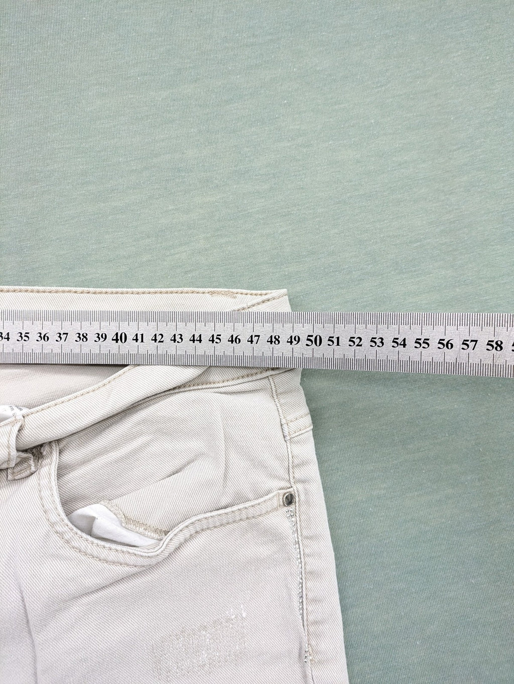 Canda beige straight jeans with strass details and classic five-pocket design.