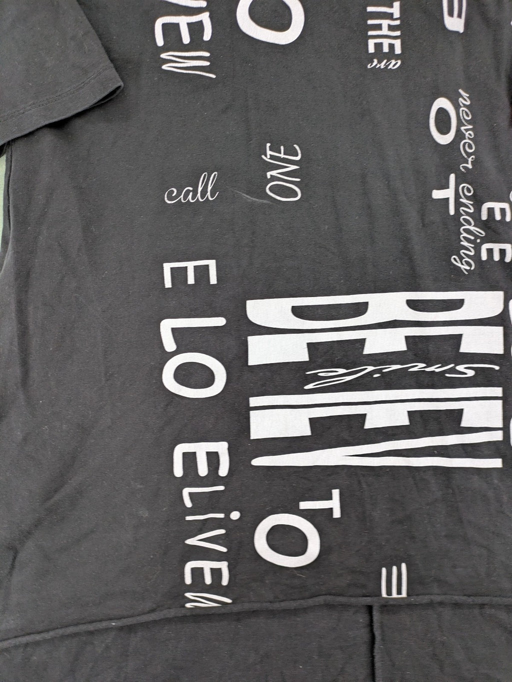 MEGI Collection black hoodie dress with graphic print and asymmetrical high-low hem.