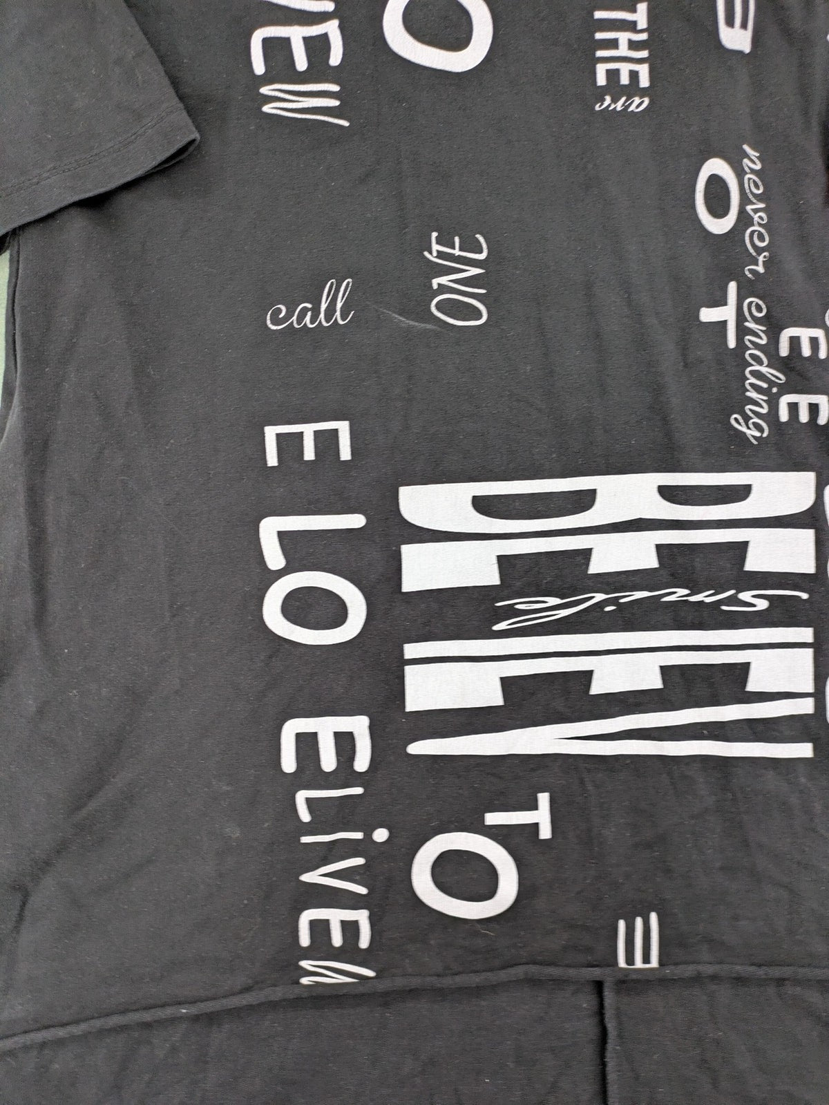 MEGI Collection black hoodie dress with graphic print and asymmetrical high-low hem.