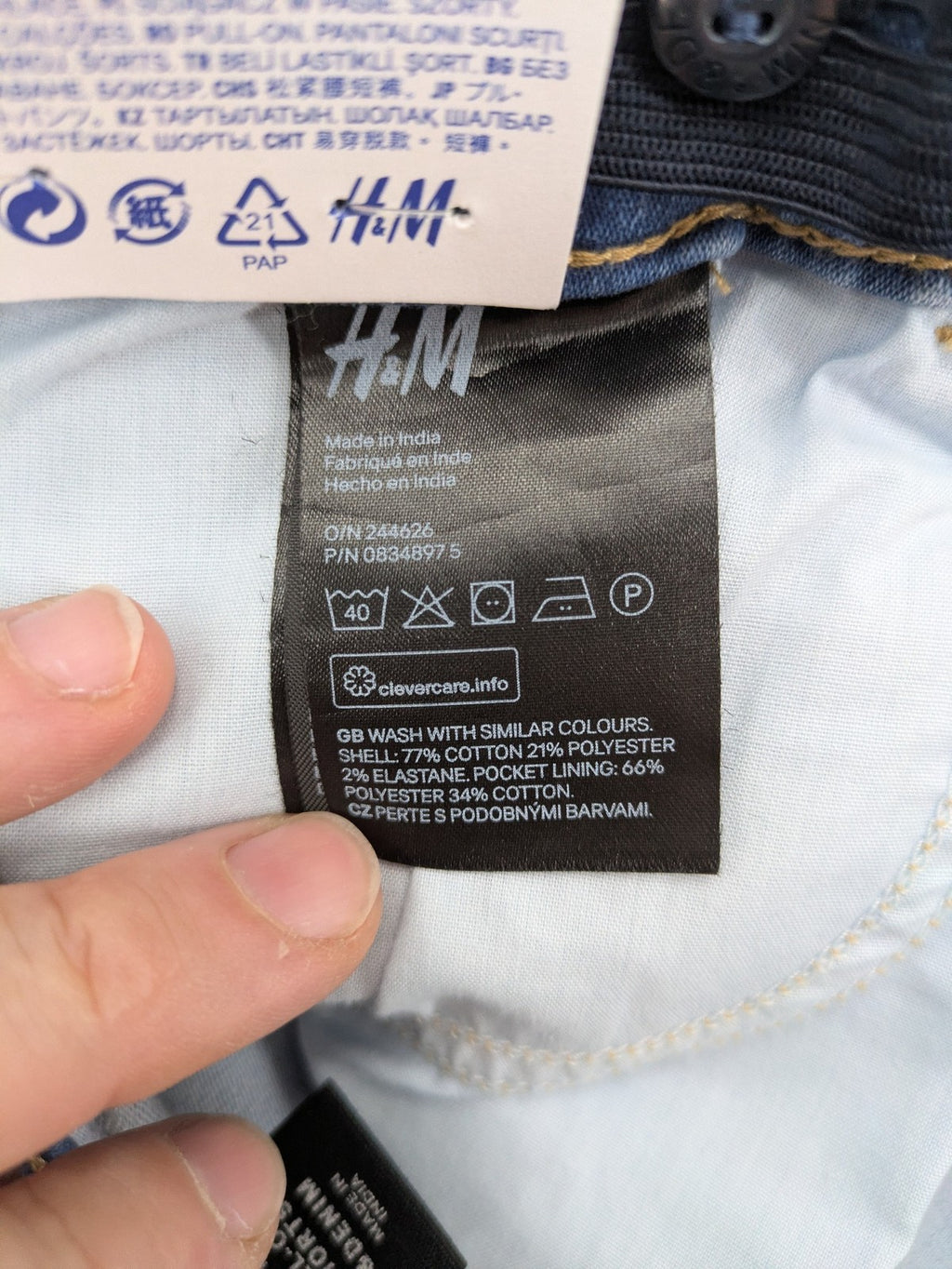 H&M blue denim shorts with adjustable drawstring, rolled hem, classic 5-pocket design.