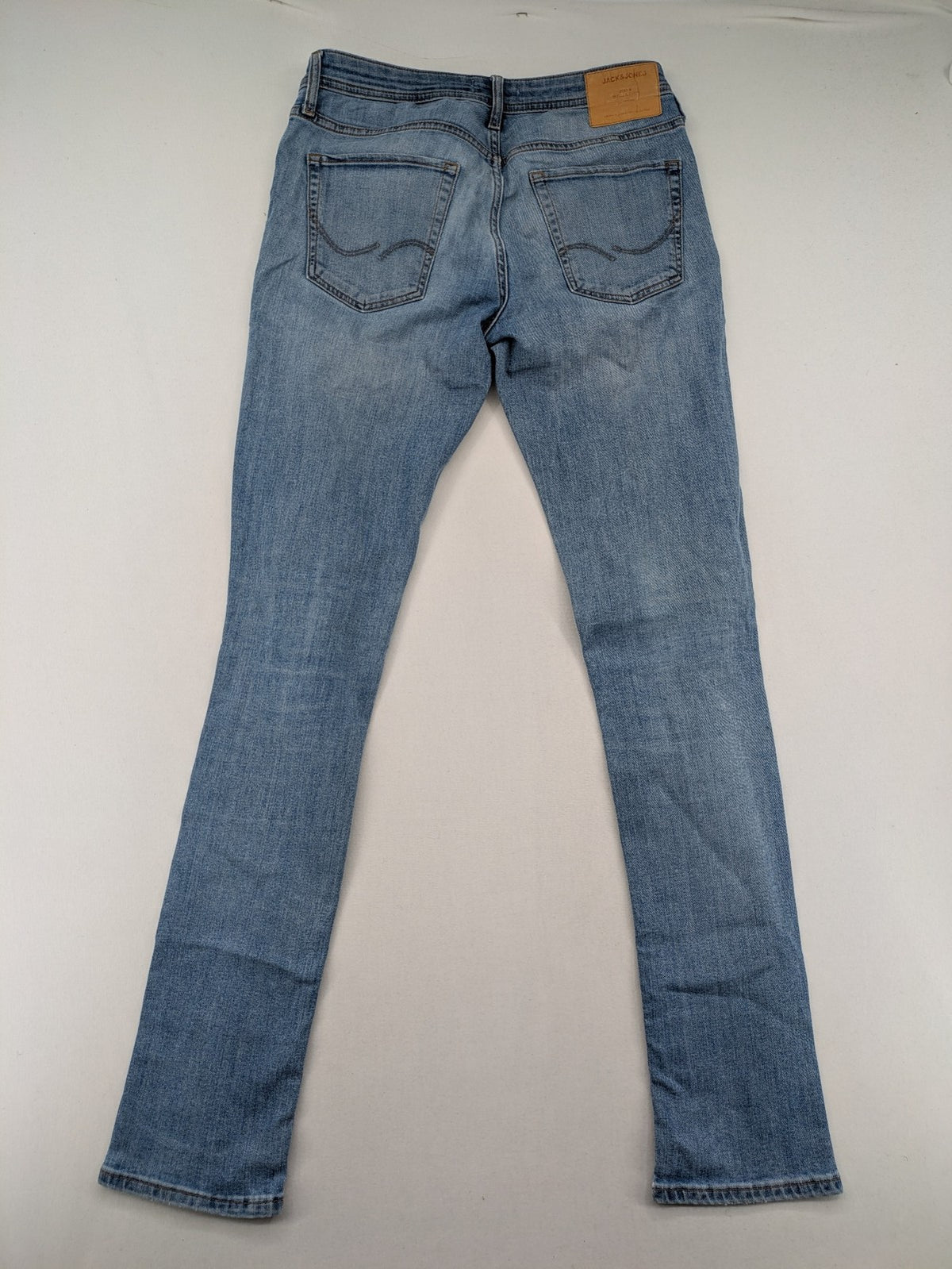 Jack & Jones blue slim jeans with button fly and subtle used look.