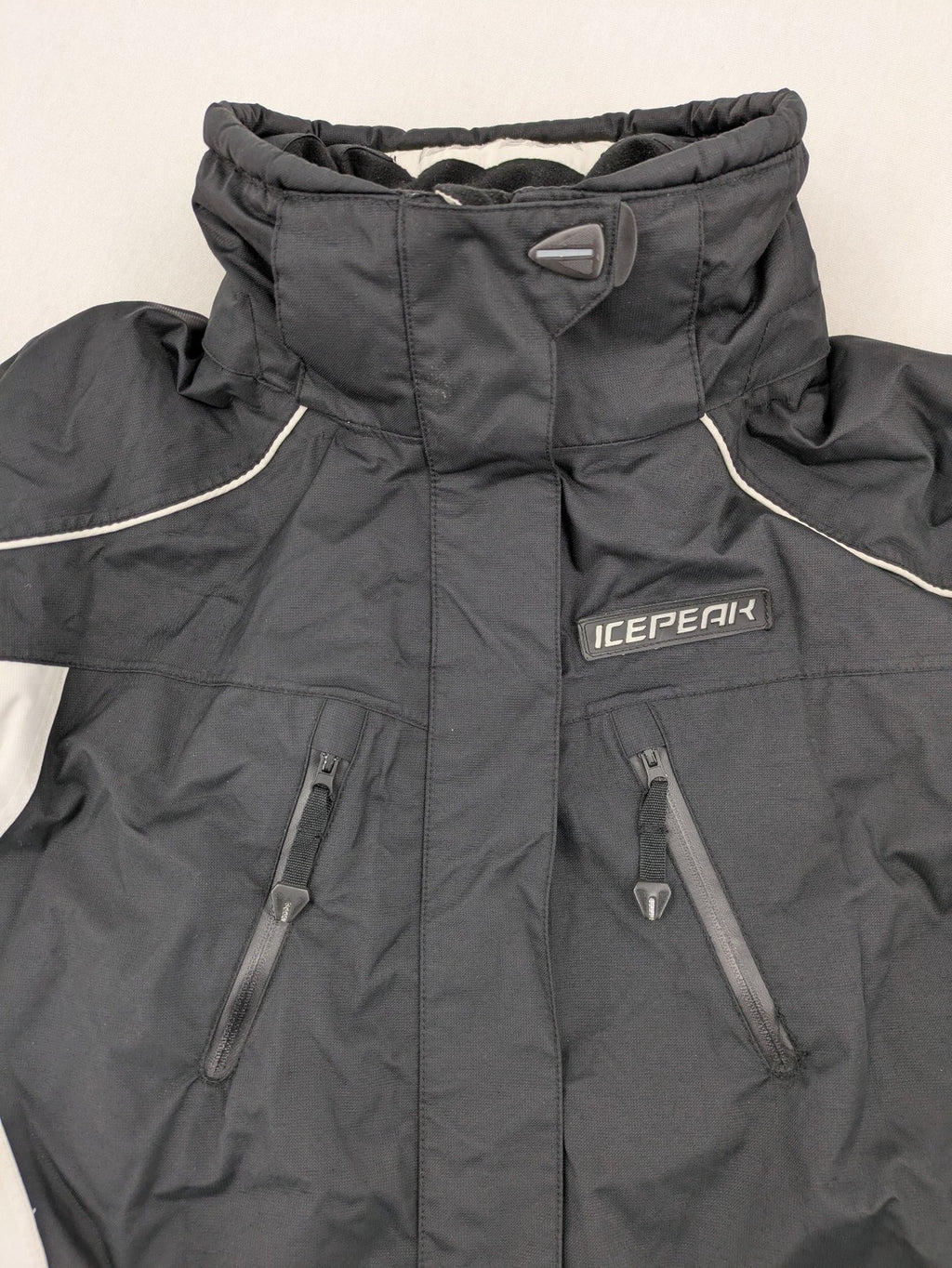 Icepeak black and white ski snowboard jacket with RECCO logo and quilted insulation.