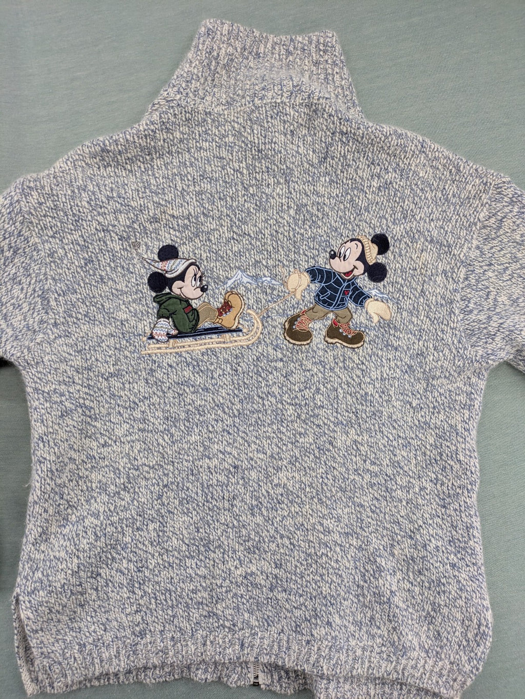Disney blue turtle neck jumper with grey Mickey and Minnie Mouse embroidery, zip closure.