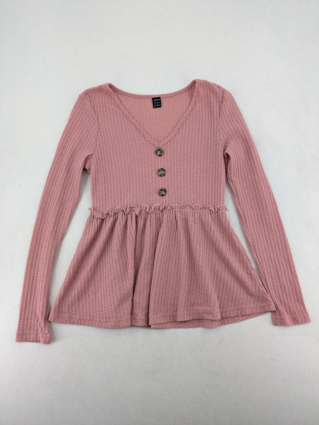 SHEIN pink top V-neck with ruffled waist and three decorative buttons, waffle knit fabric.