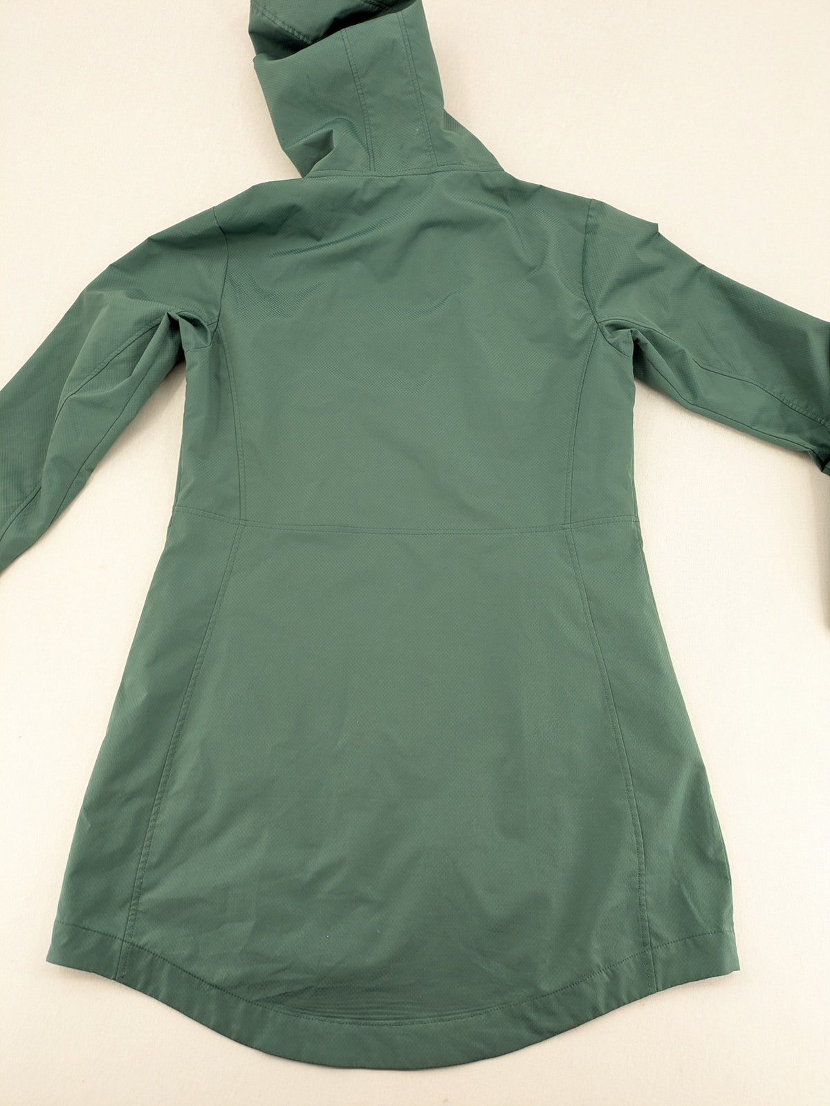 Frilufts green softshell jacket with hood, longline design, durable zipper, practical zip pockets.