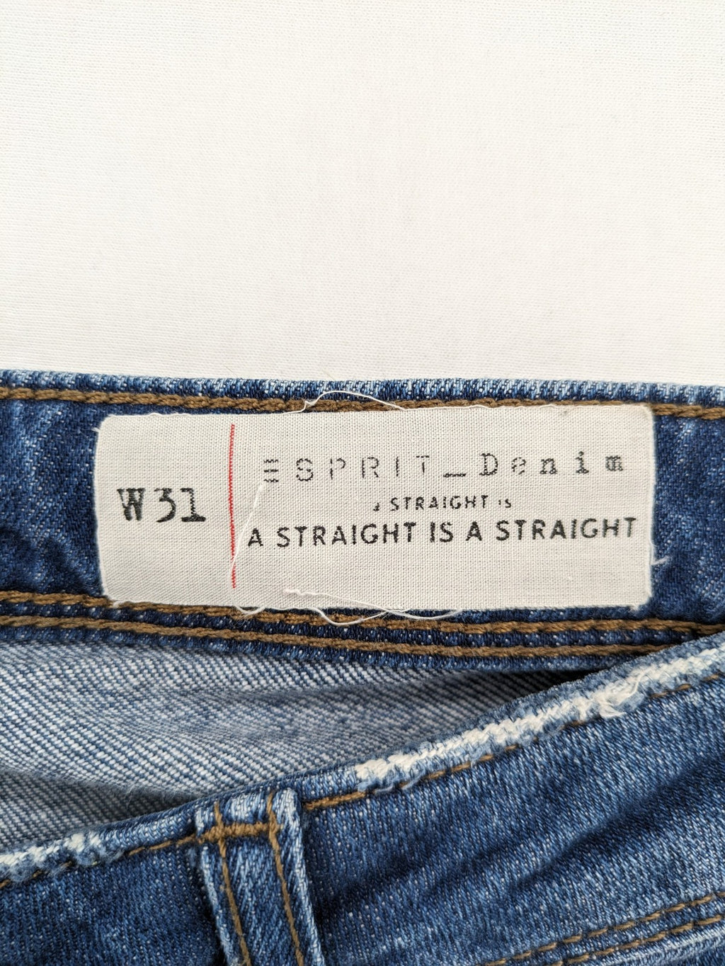 Esprit blue straight leg jeans with ripped knee details and rolled hem.