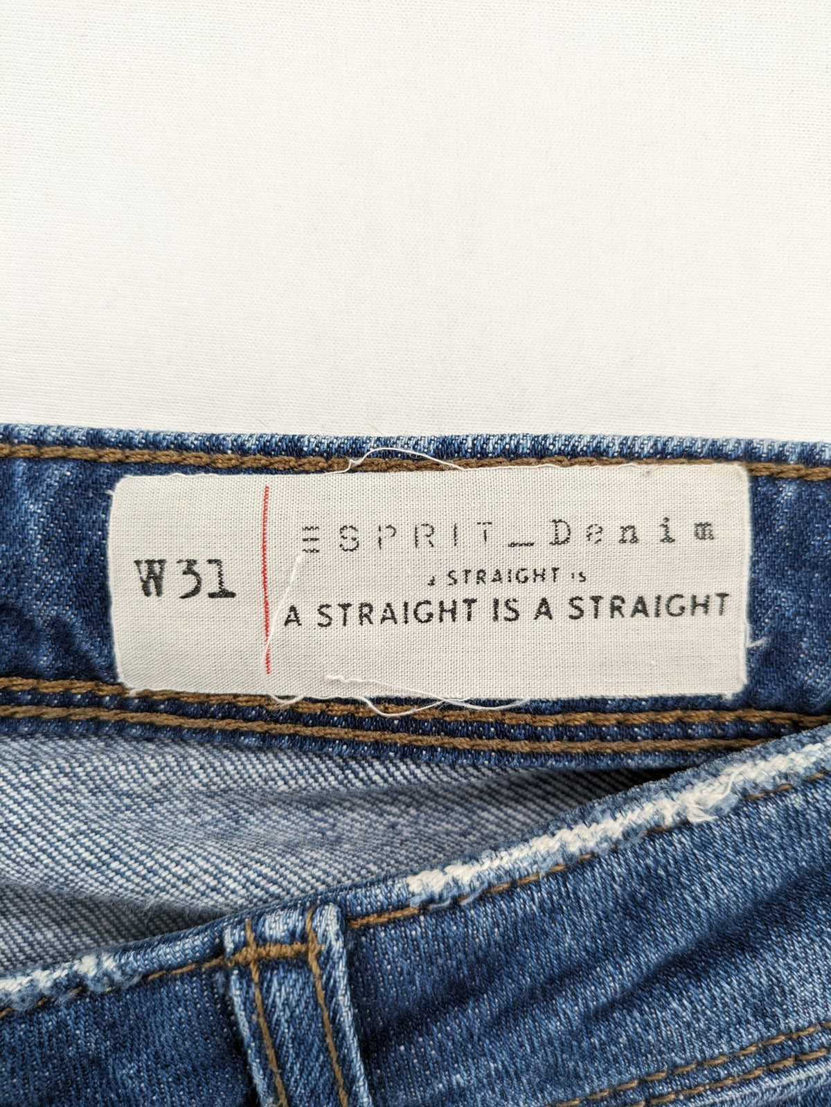 Esprit blue straight leg jeans with ripped knee details and rolled hem.