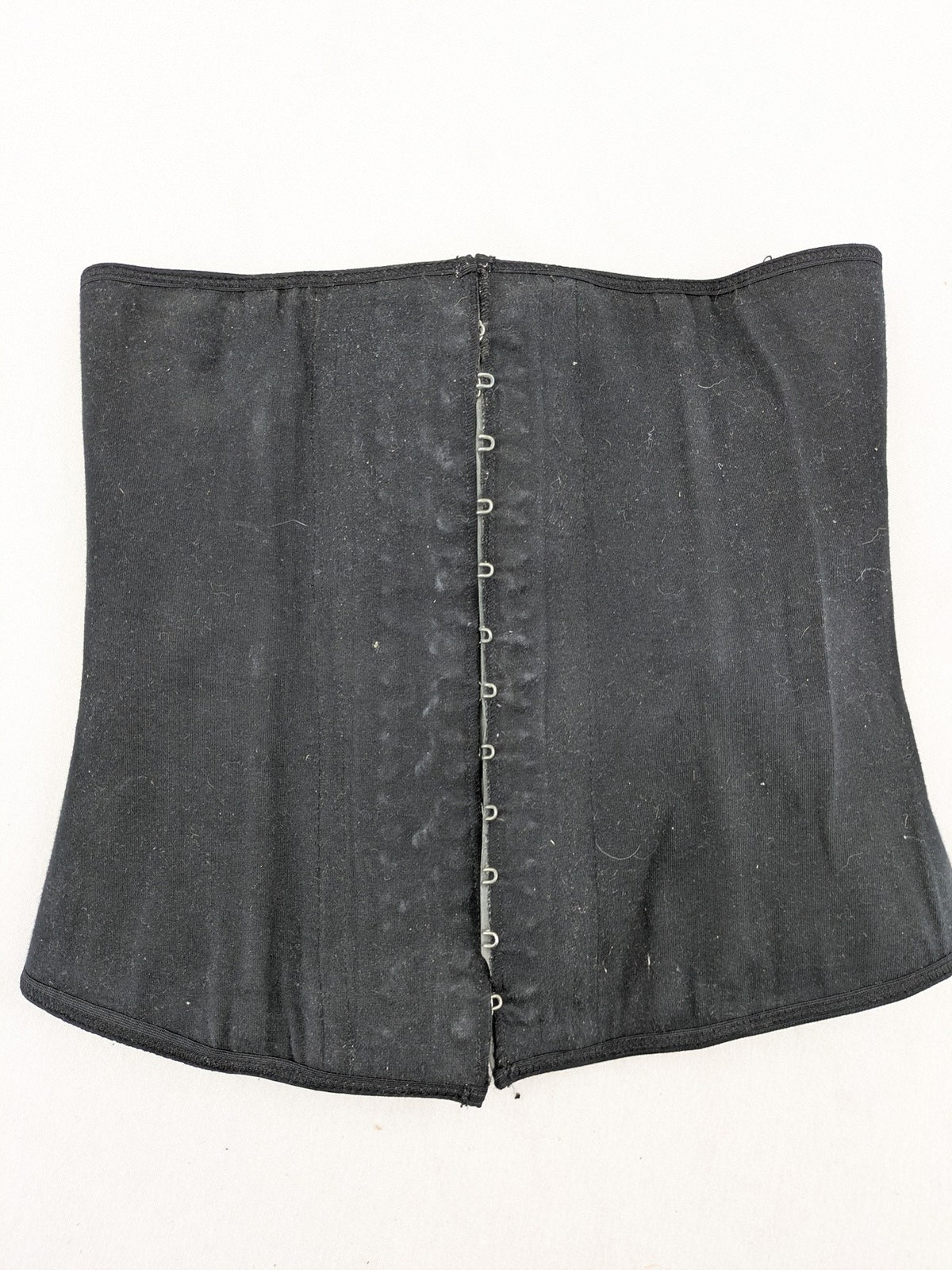 Faja black shapewear body shaper with multiple hook-and-eye closures and latex core.