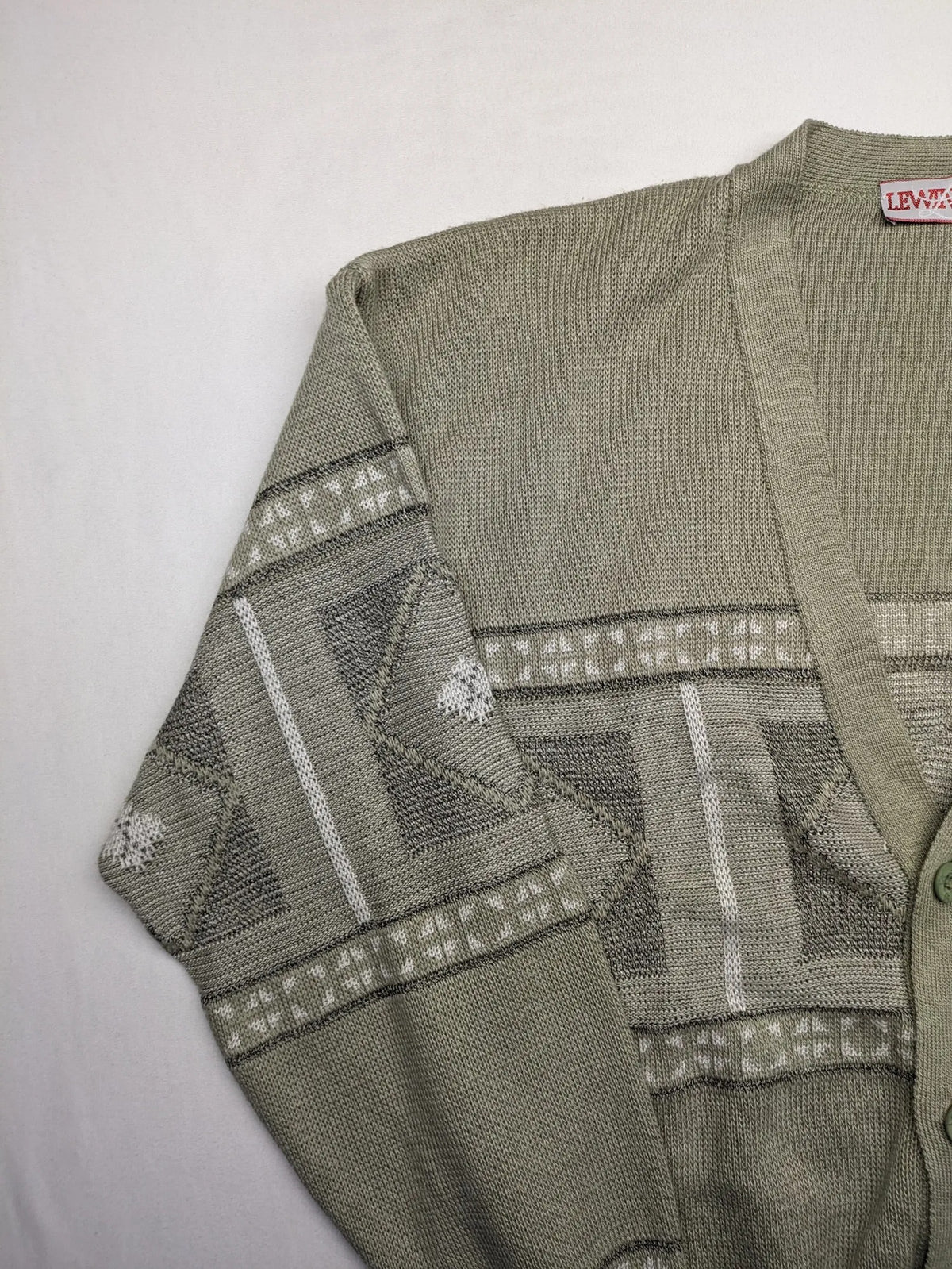Lewträger cream and grey turtle neck jumper with geometric pattern and button placket.