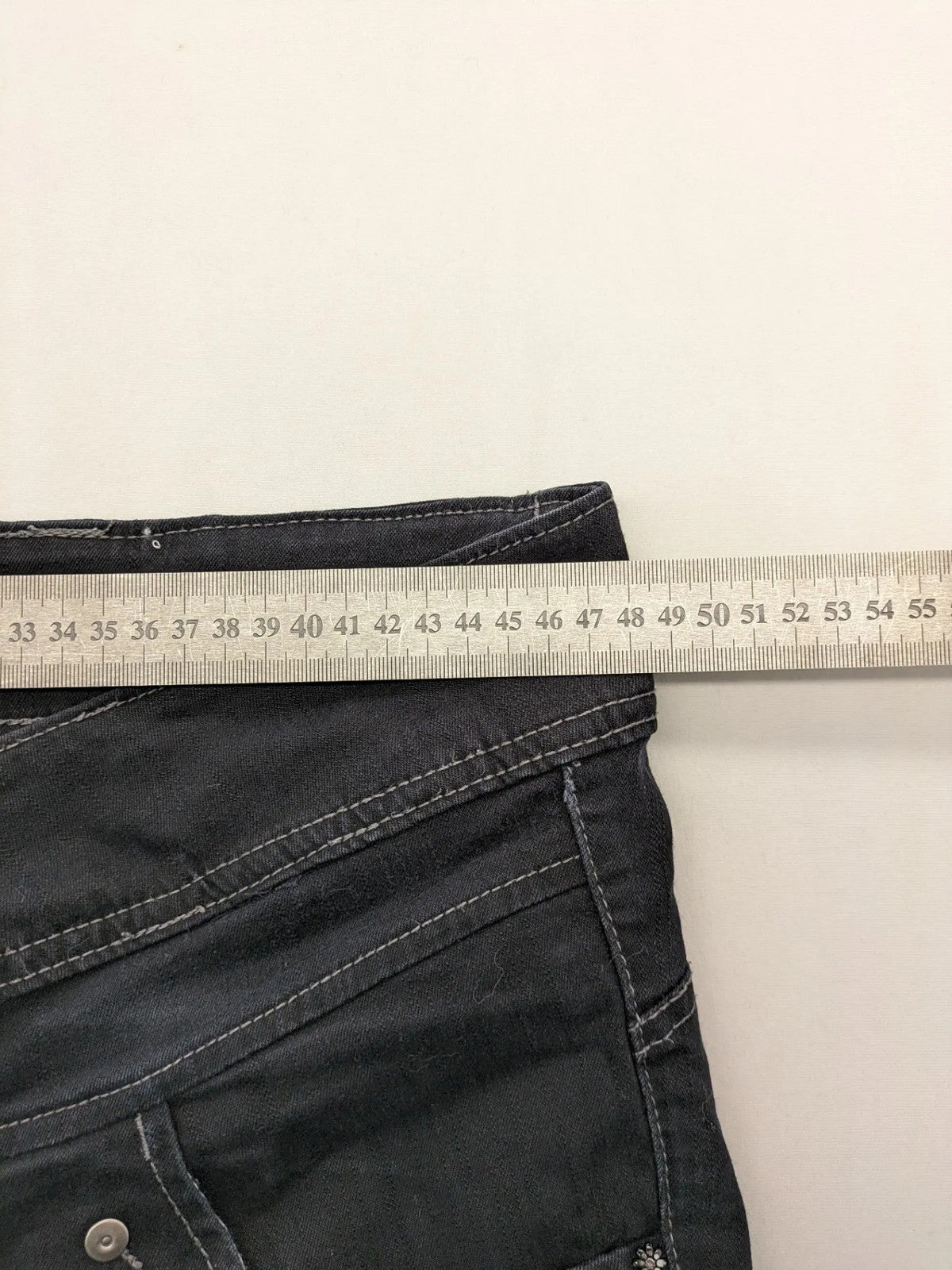 Okay grey straight jeans with contrast stitching and three-button closure, cotton stretch material.