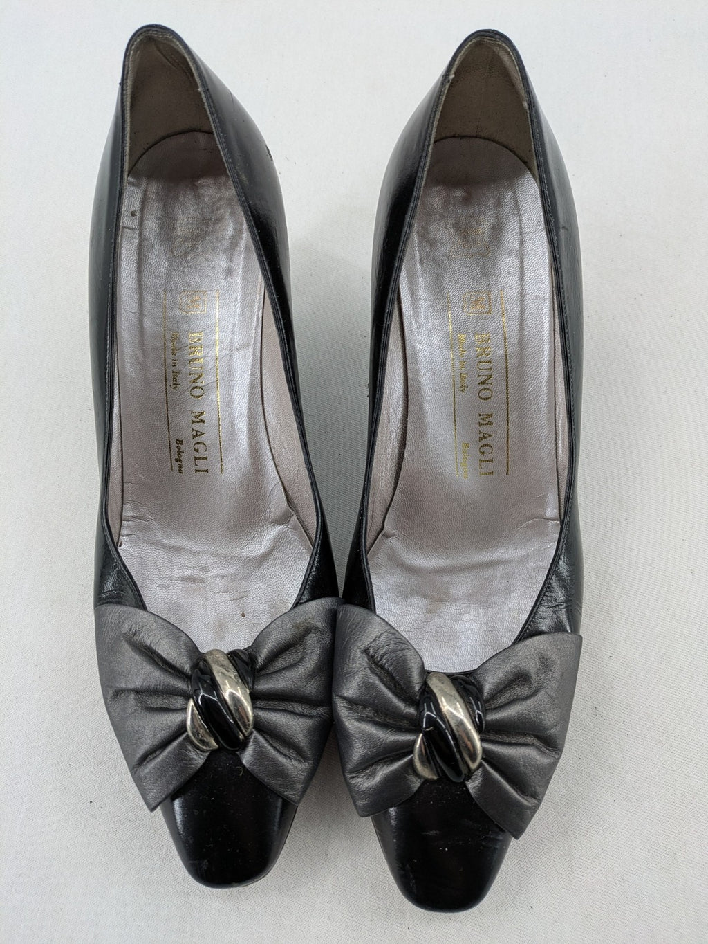 Bruno Magli black high heels leather with grey bow detail and classic silhouette.