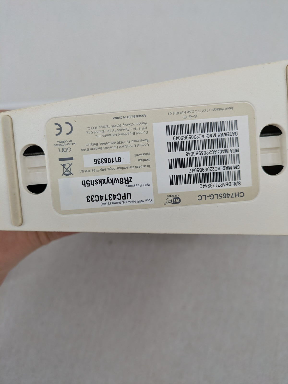 Compal beige WLAN modem router with integrated Wi-Fi and multiple LAN ports.