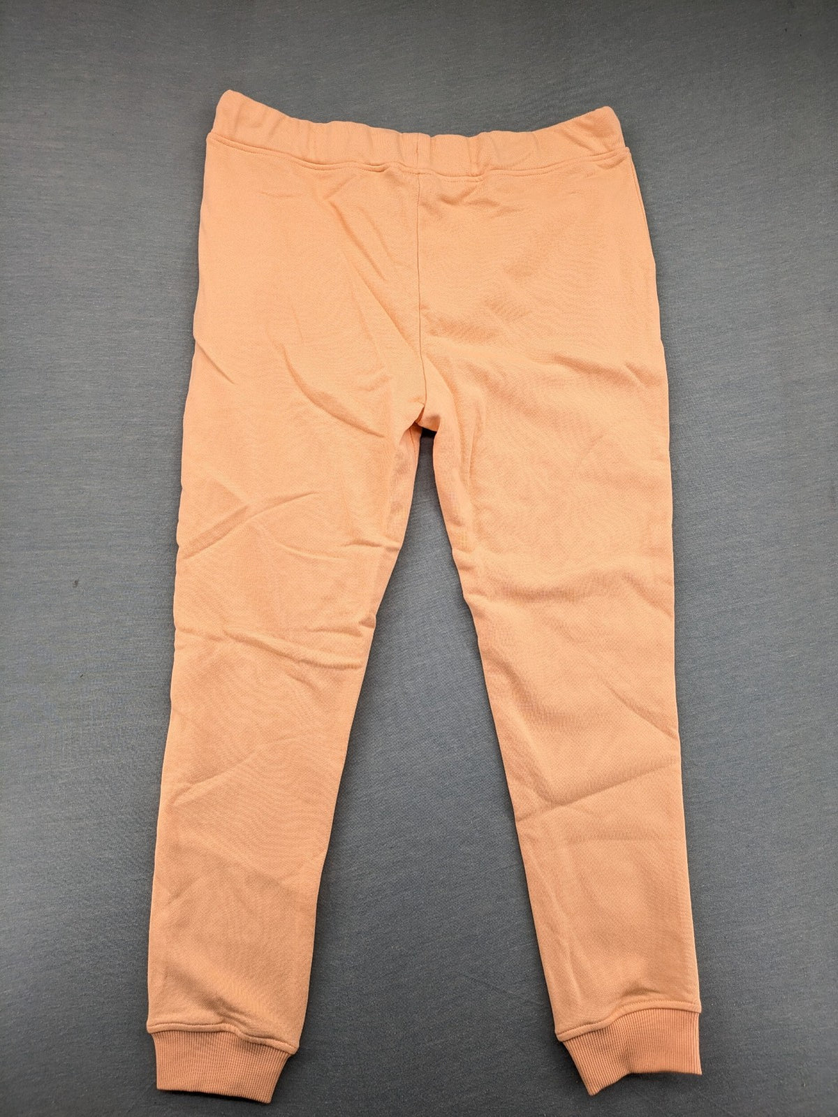 U.S. Polo Assn. orange sweatpants slim fit with sequin USPA logo on leg.