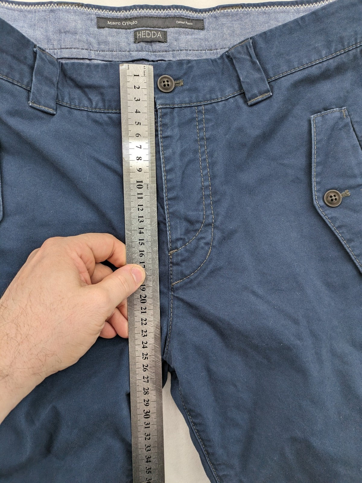 Marc O'Polo blue chino pants with button flap pockets and relaxed fit design.