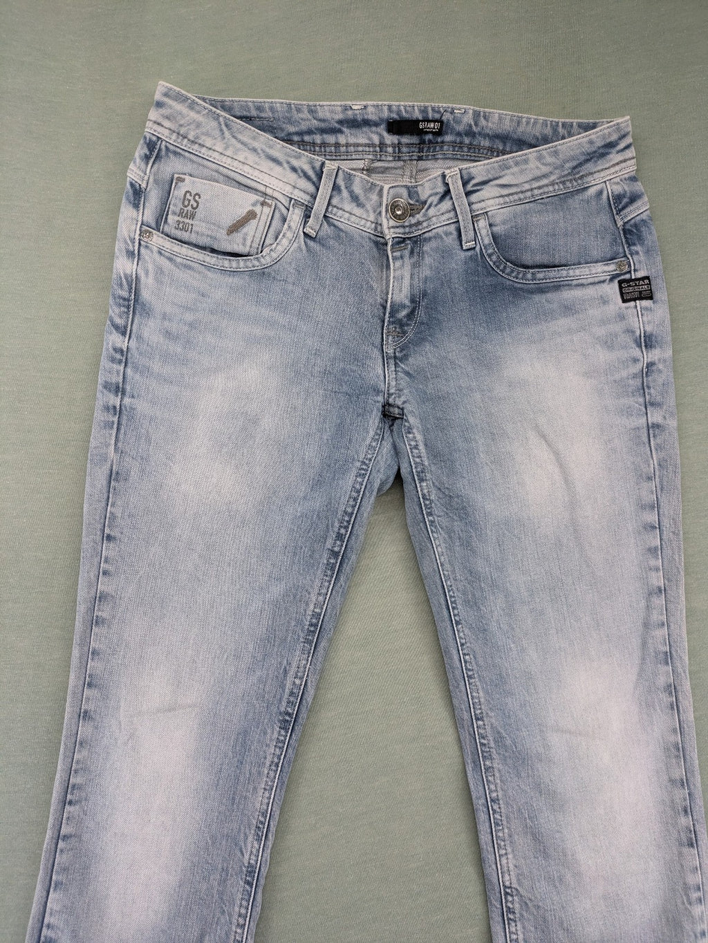 G-Star Raw blue straight leg jeans with classic 5-pocket design and light wash denim.