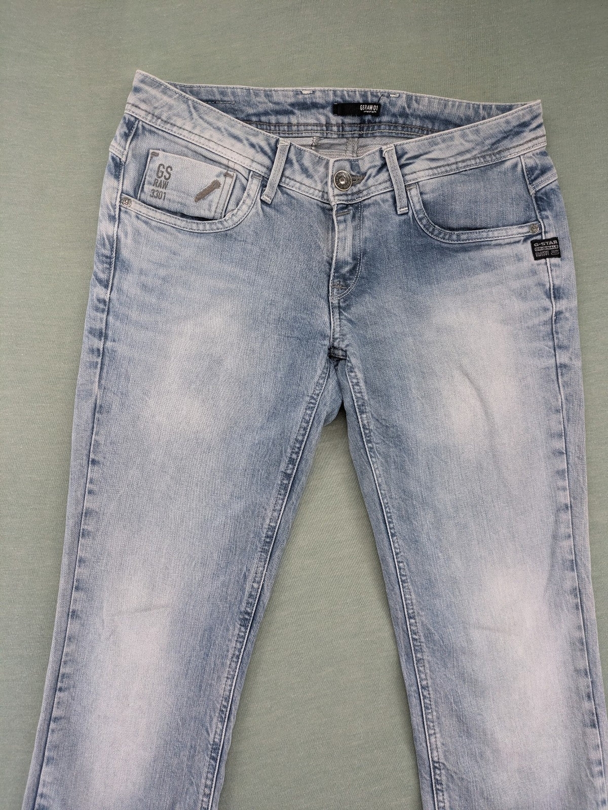 G-Star Raw blue straight leg jeans with classic 5-pocket design and light wash denim.