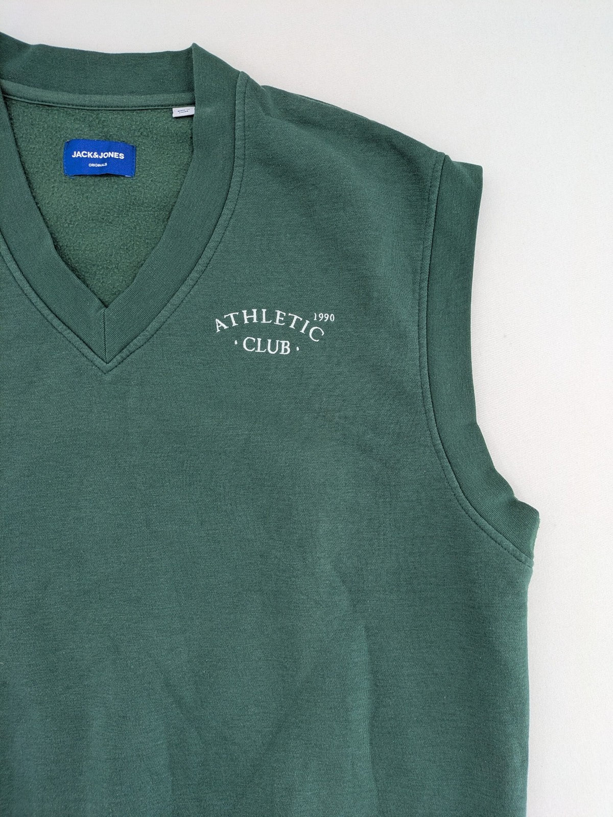 Jack & Jones Originals green vest with embroidered Athletic Club 1990 logo and V-neck.