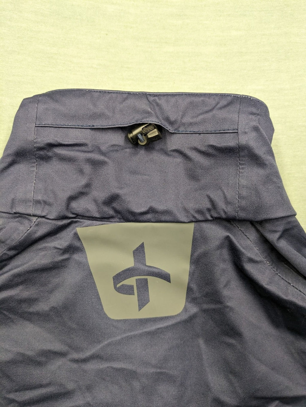 Cross Sportswear orange golf jacket with full zip, high collar, and contrast zipper details.