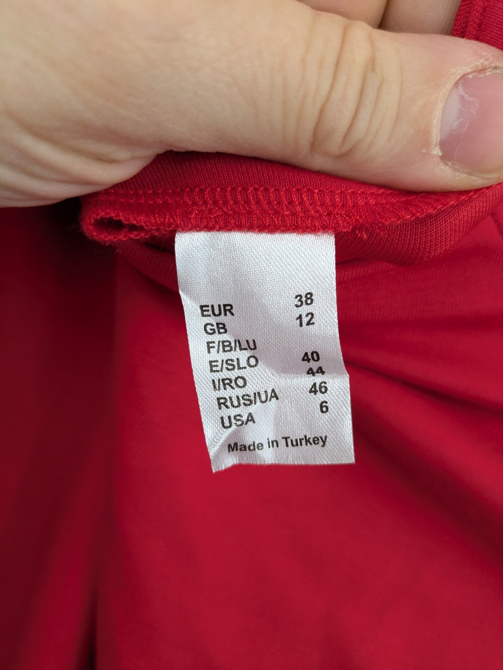 H&M red A-line dress with stand collar, 3/4 sleeves, and side pockets in stretchy jersey.