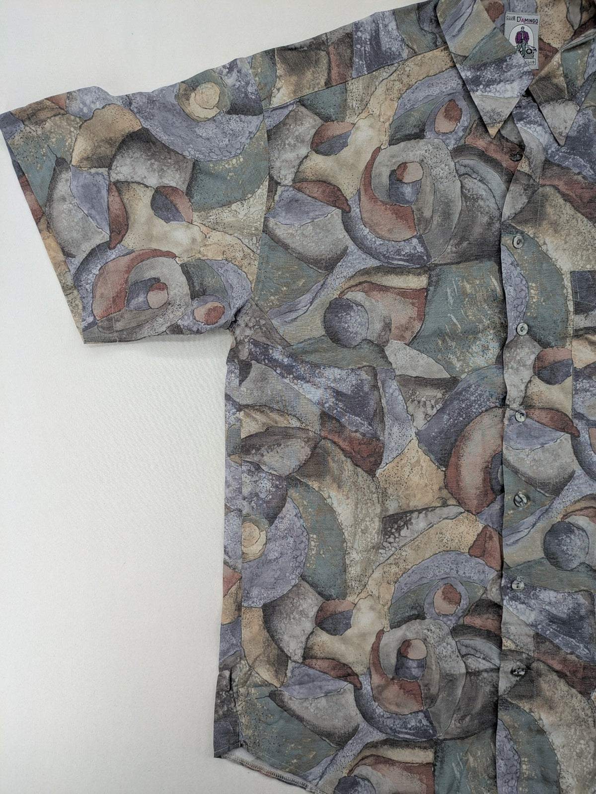 Club D'Amingo short sleeve shirt multi abstract geometric pattern in earthy tones.