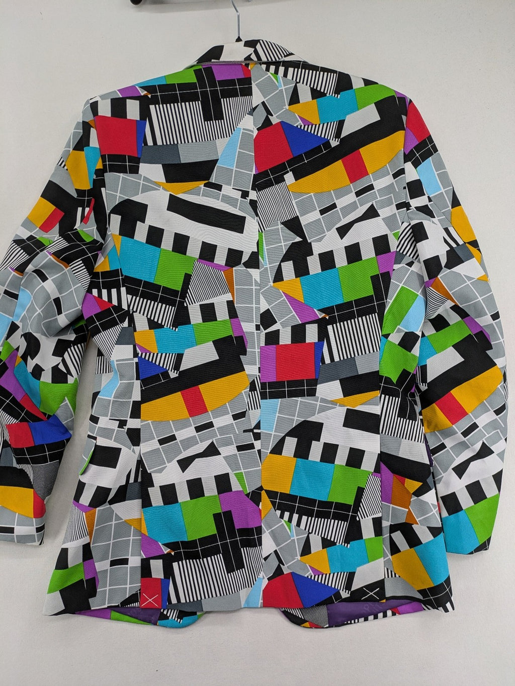 Opposuits blue and green blazer with vibrant geometric pattern and purple satin lining.