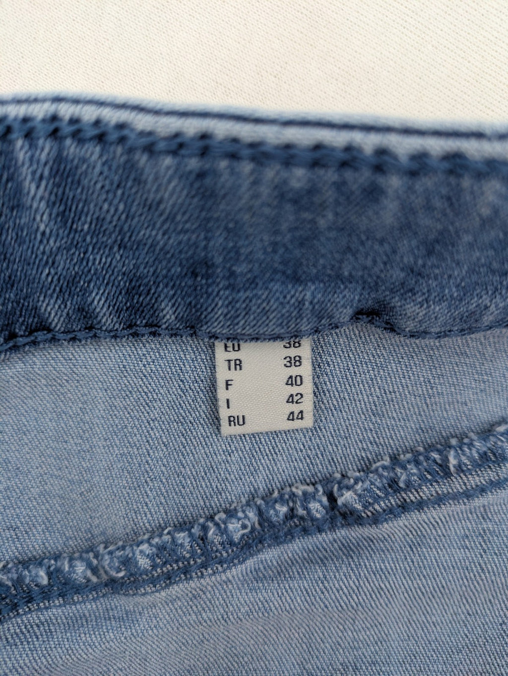 Tchibo blue A-line denim skirt classic five-pocket design with zipper and button closure.
