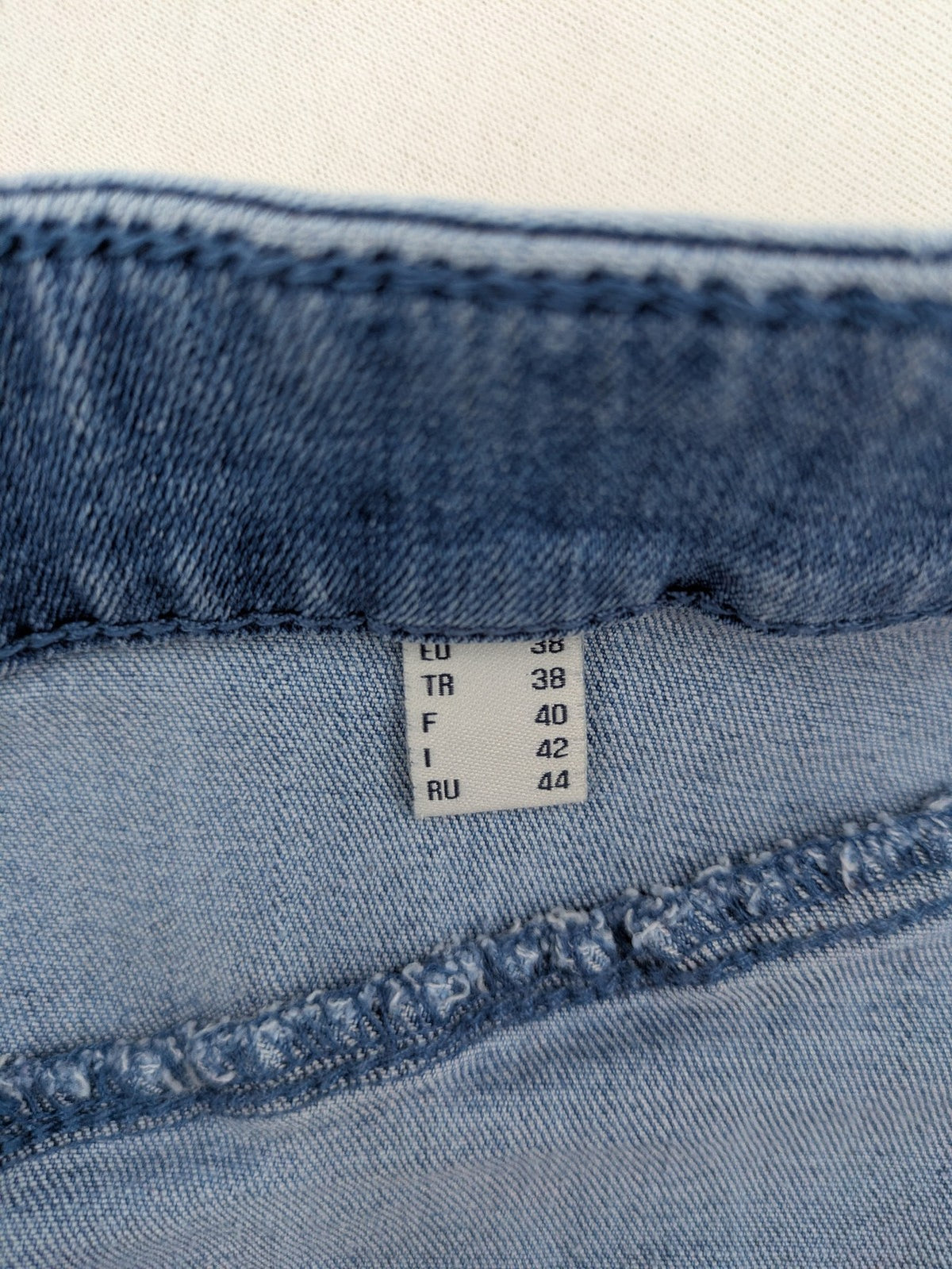 Tchibo blue A-line denim skirt classic five-pocket design with zipper and button closure.