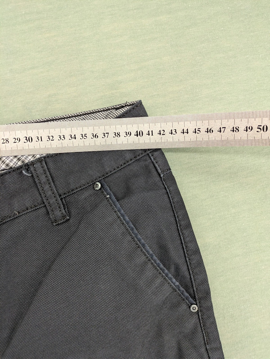 Rooney grey chino pants with checkered waistband and buttoned back pockets.
