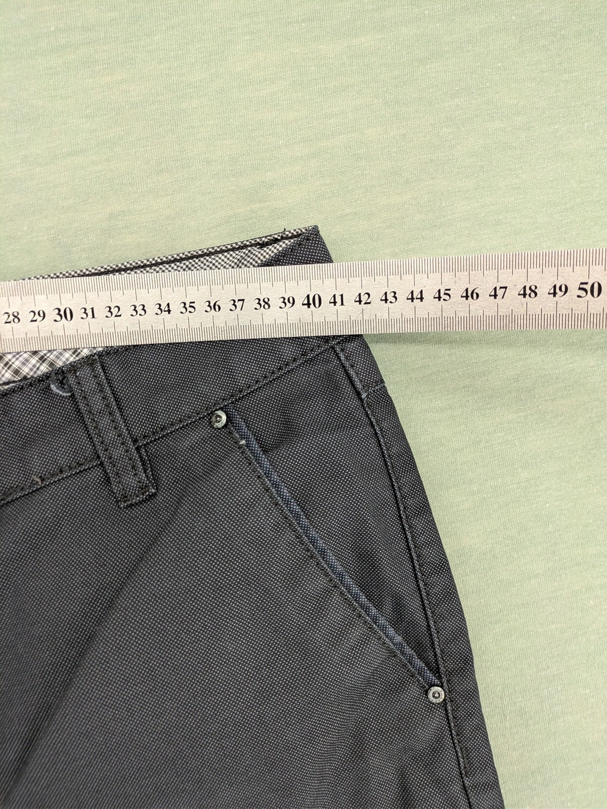 Rooney grey chino pants with checkered waistband and buttoned back pockets.