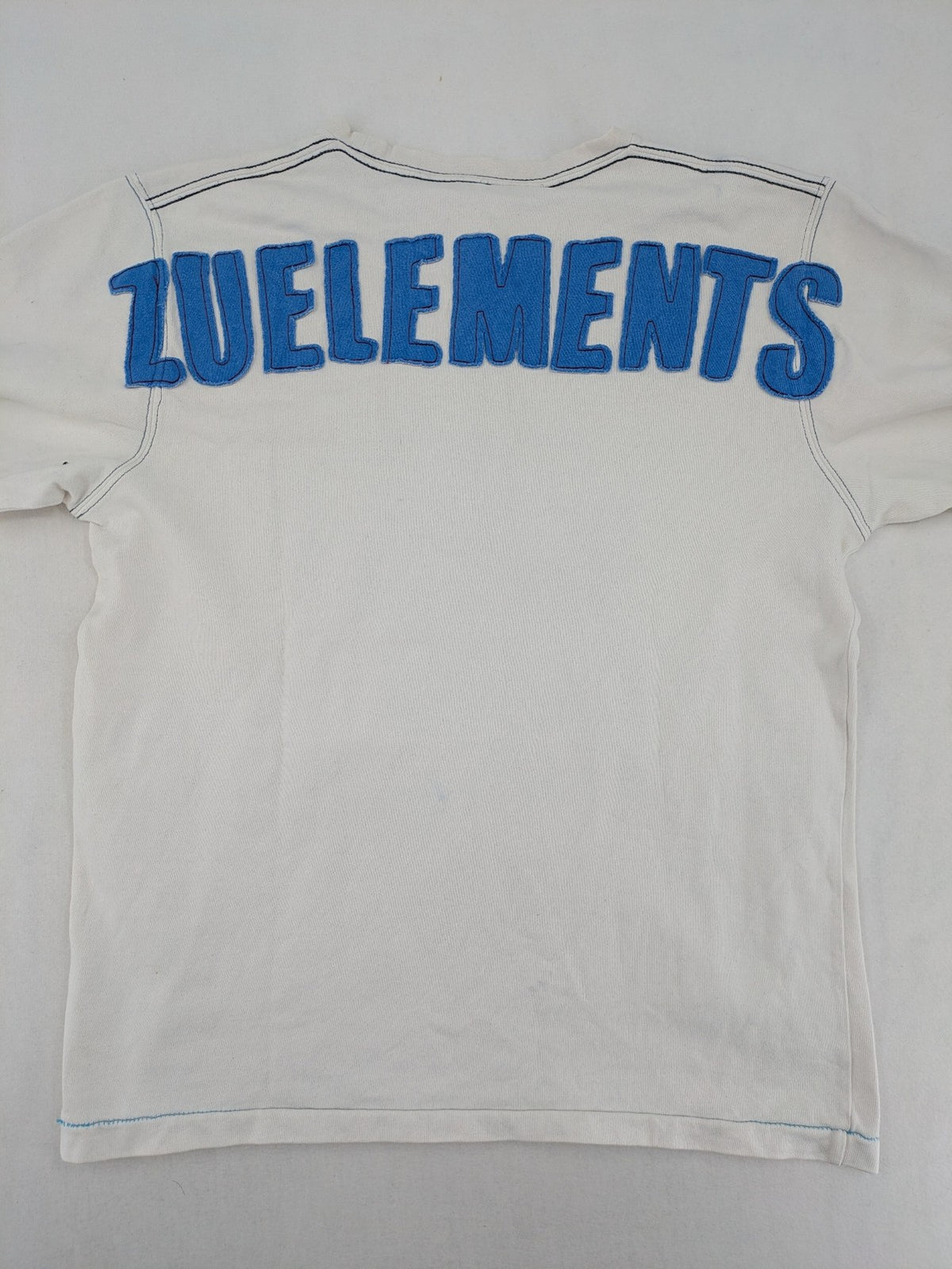 Zuelements black turtle neck jumper with red wing graphic and large blue logo.