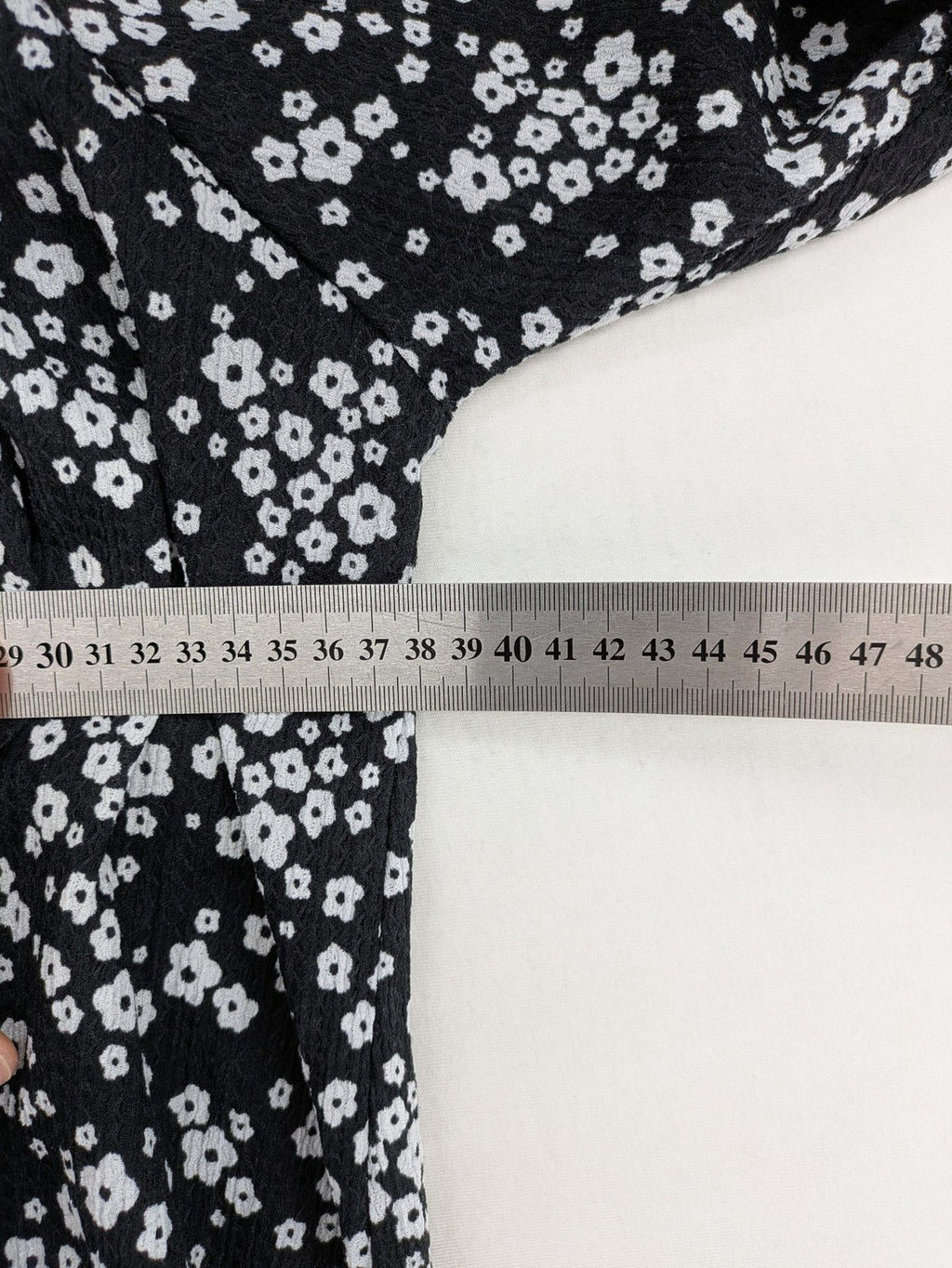 Clockhouse black and white floral mini dress with smocked bodice and puff sleeves.