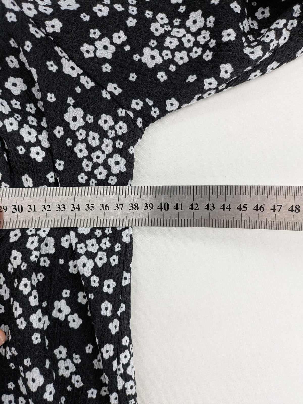 Clockhouse black and white floral mini dress with smocked bodice and puff sleeves.