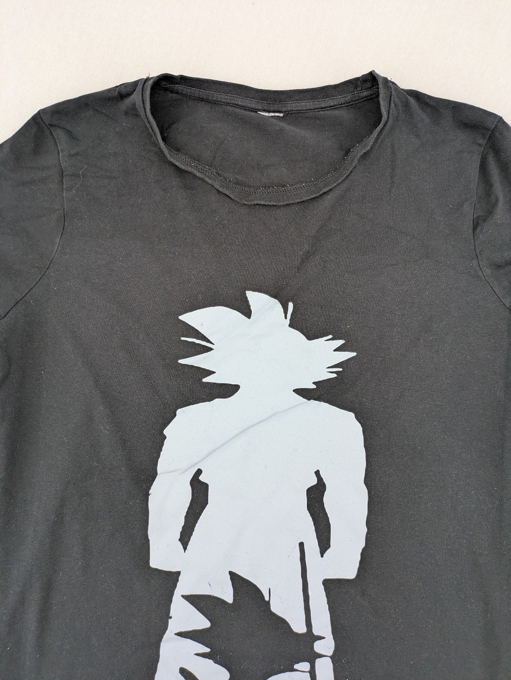 Dragon Ball Z black t-shirt featuring blue Son Goku silhouette graphic design.