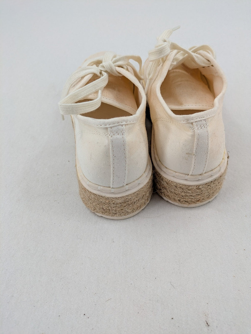 H&M beige espadrille sneakers with jute sole and cream canvas upper.