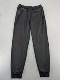 Kalenji black loungewear pants with grey accents and zippered side pockets.