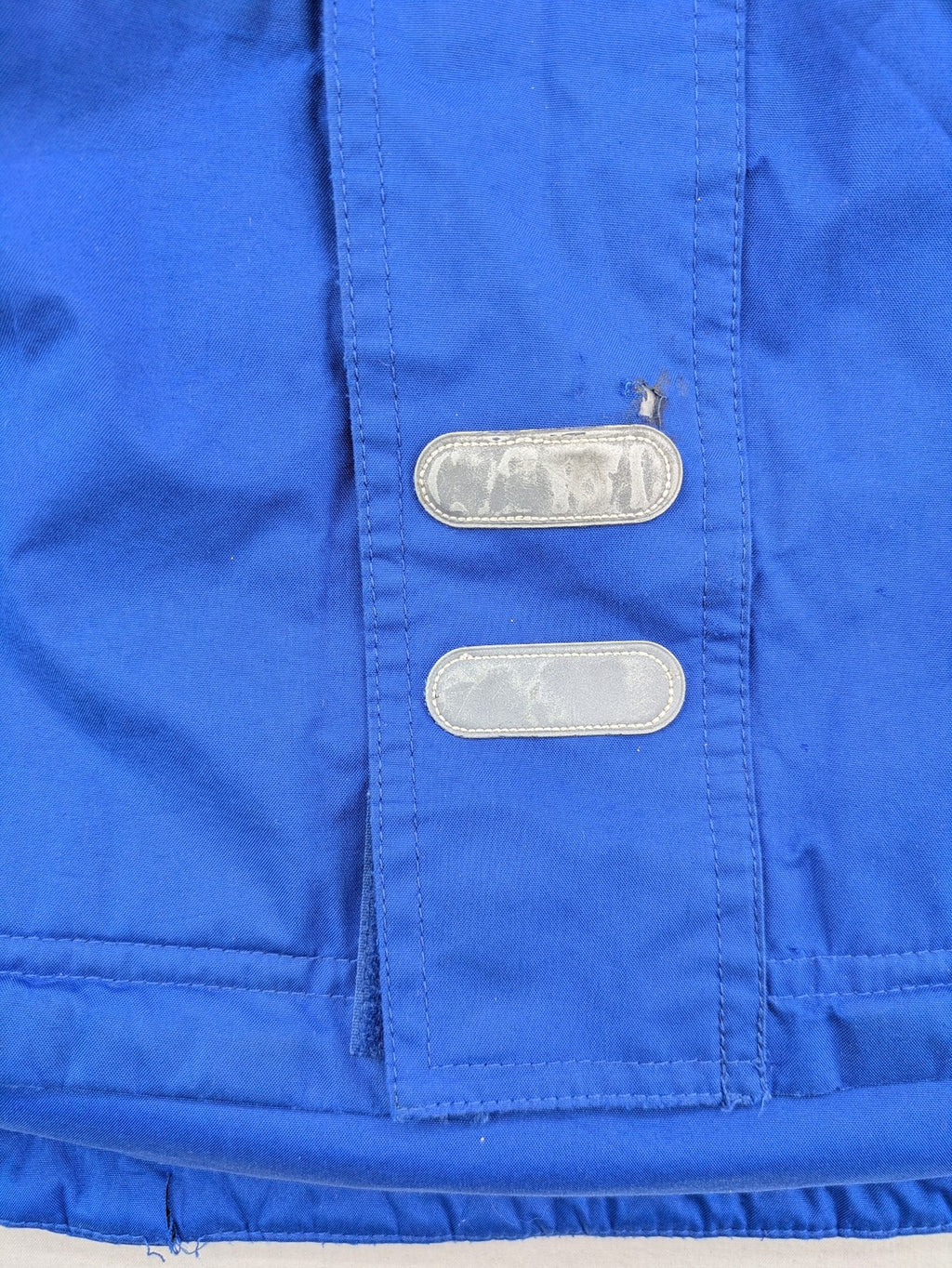Umbro blue fleece-lined jacket with hood, reflective details, and white piping.