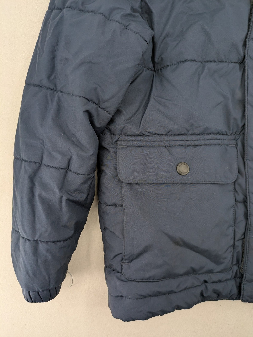 Jack Wolfskin cream and navy puffer coat with quilted design and Sherpa fleece lining.