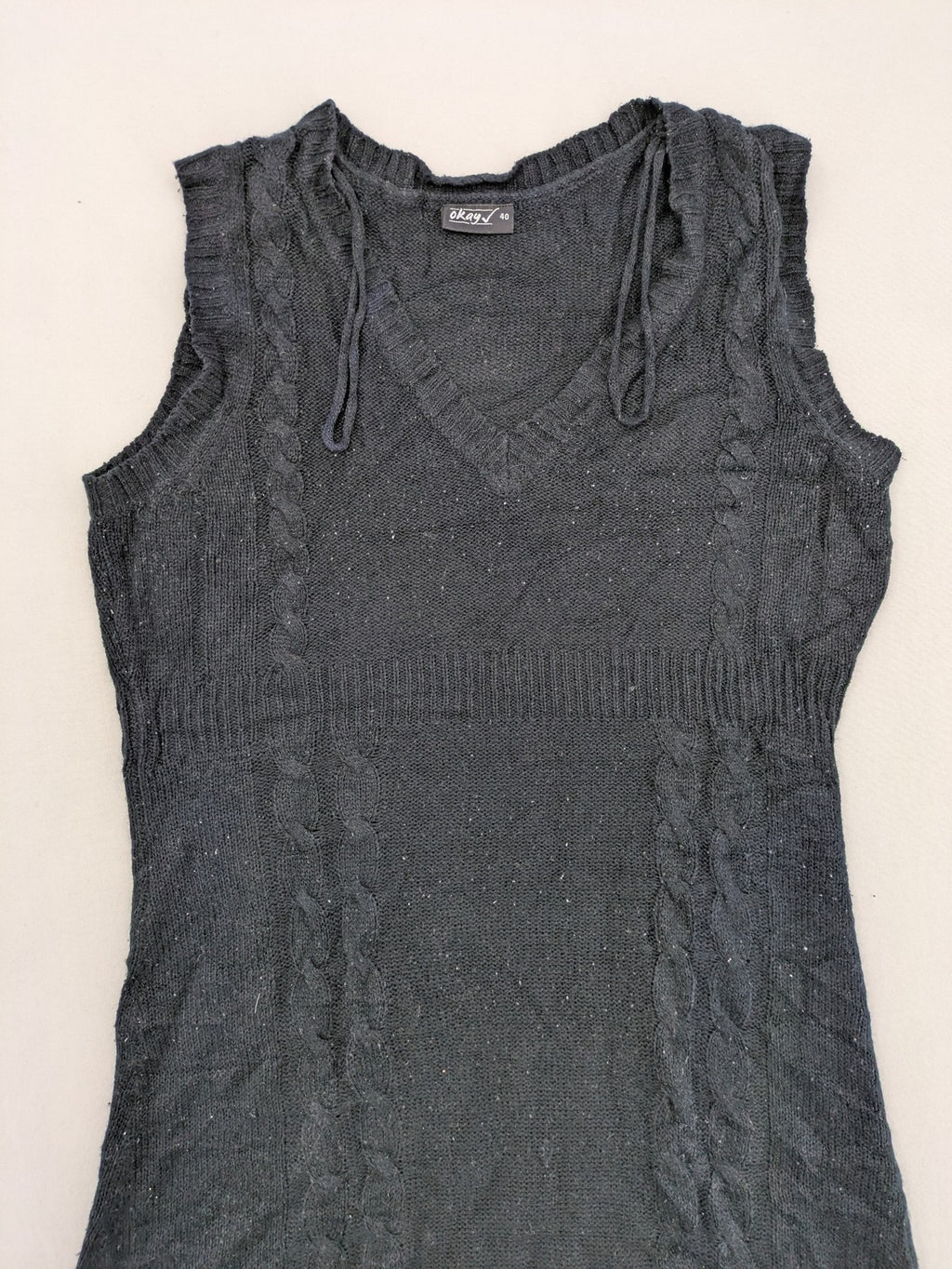 Okay black sleeveless dress V-neck with decorative cord and cable knit pattern.