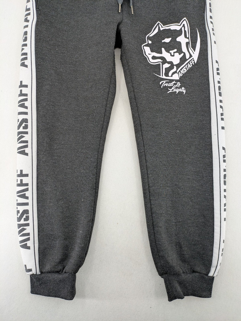 Amstaff grey sweatpants with large dog logo and "Trust & Loyalty" text.