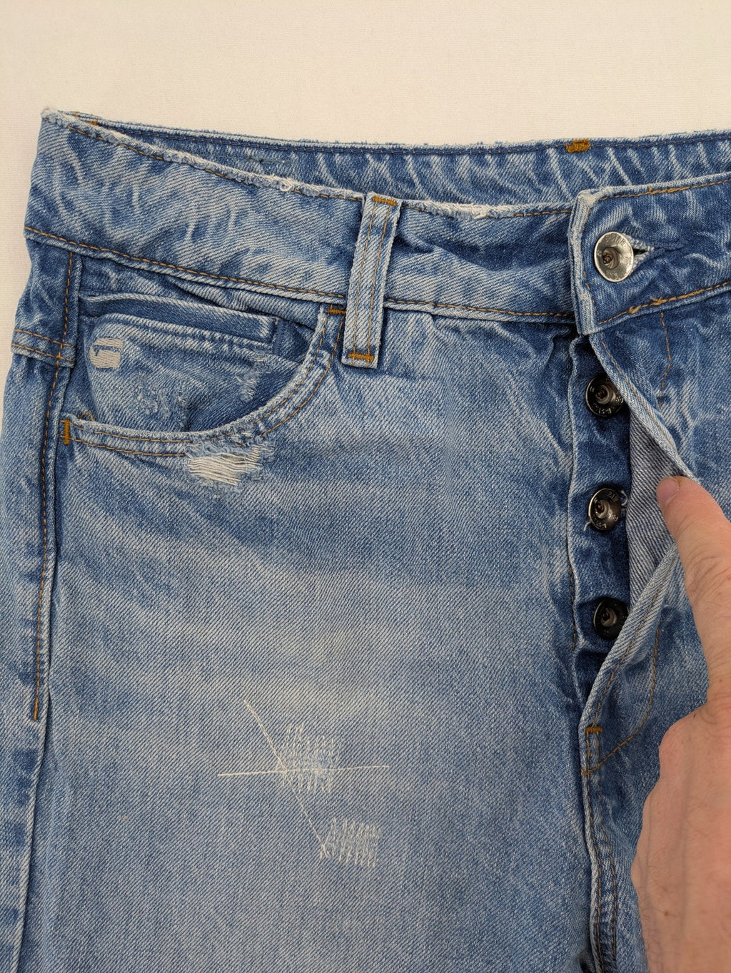 G-Star Raw blue distressed high boyfriend jeans with ripped details and classic button closure.