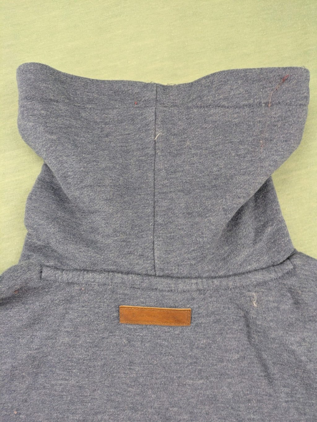 Naketano grey turtle neck jumper with thick drawstring and leather logo appliqué.