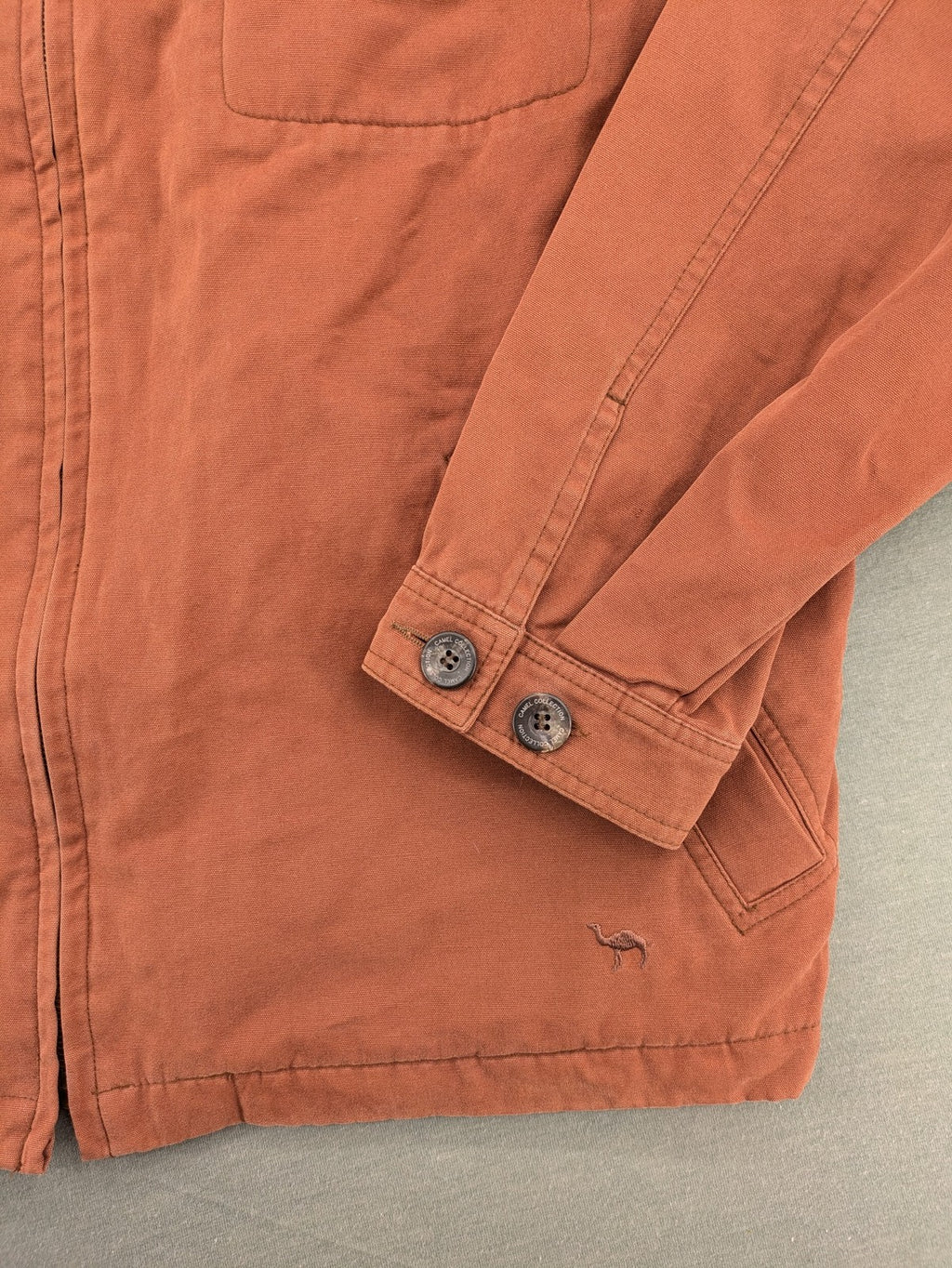 Camel Collection brown jacket with orange contrast collar and embroidered logo.