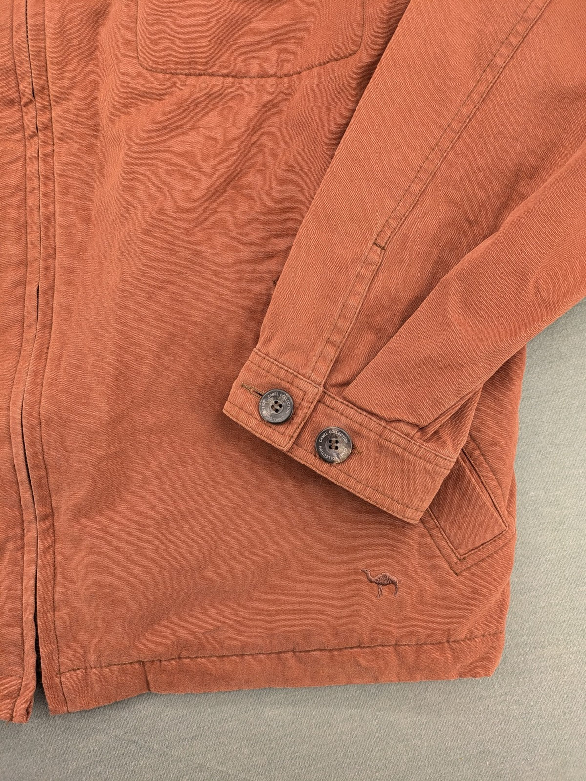 Camel Collection brown jacket with orange contrast collar and embroidered logo.