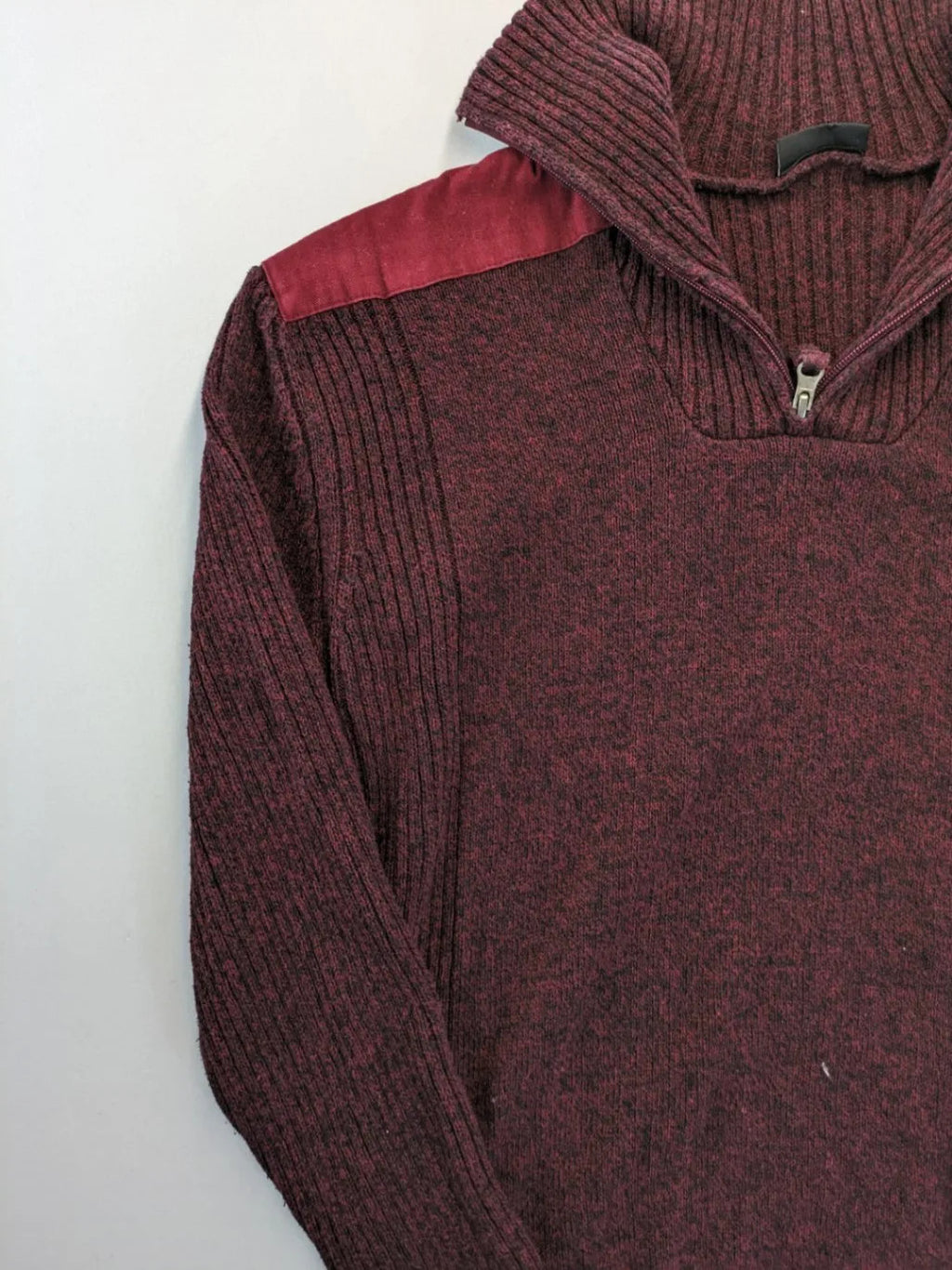 Infinity burgundy turtle neck jumper with quarter-zip and ribbed knit texture.