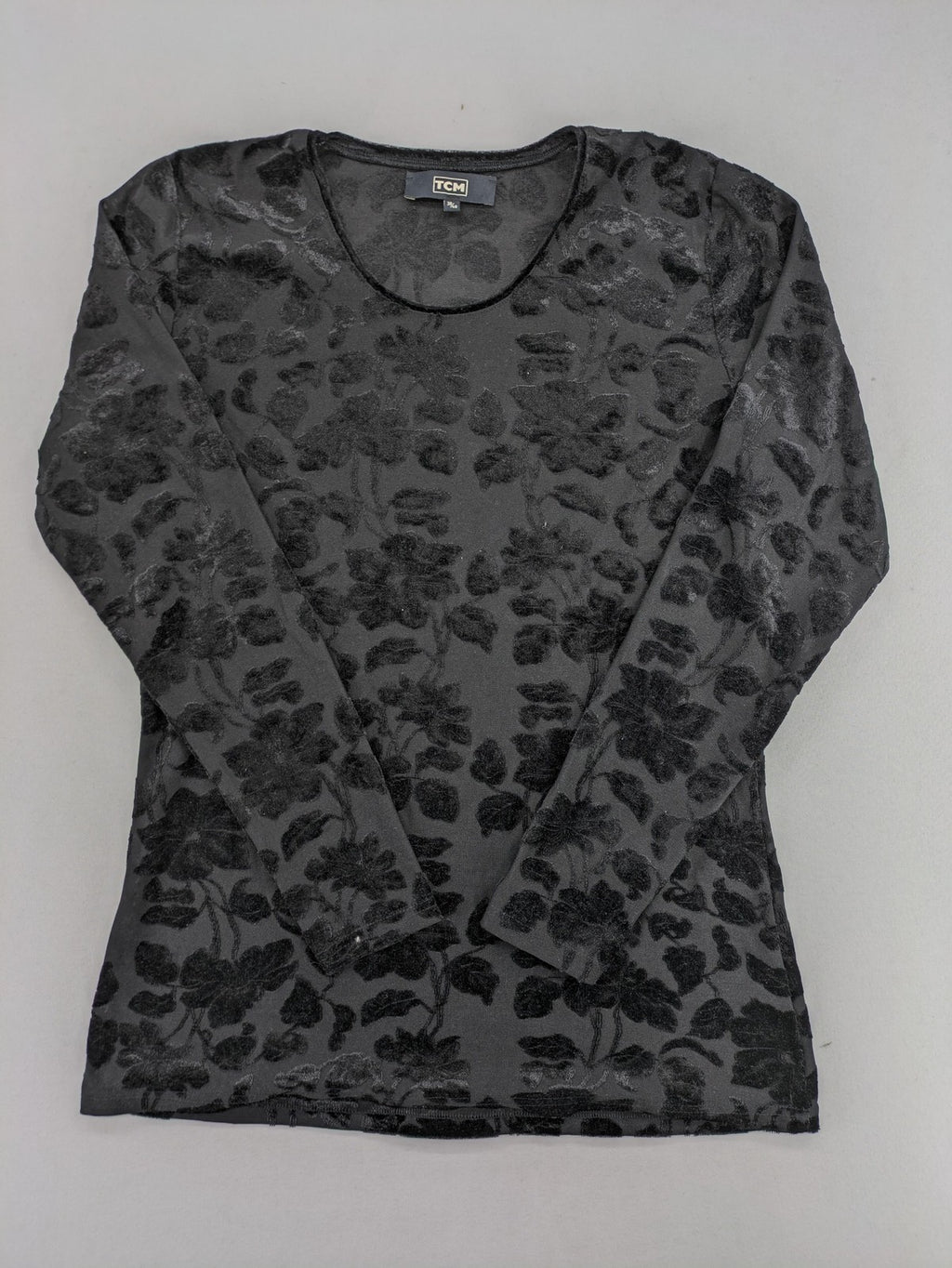 TCM black long sleeve top with floral flock print on sheer fabric.