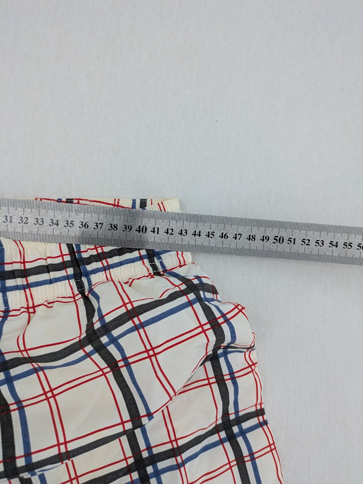 Crivit multi-coloured board shorts with classic check pattern and adjustable drawstring waistband.