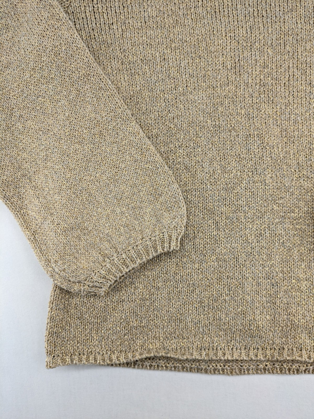 Rick Cardona beige turtle neck jumper with gold metallic thread and balloon sleeves.