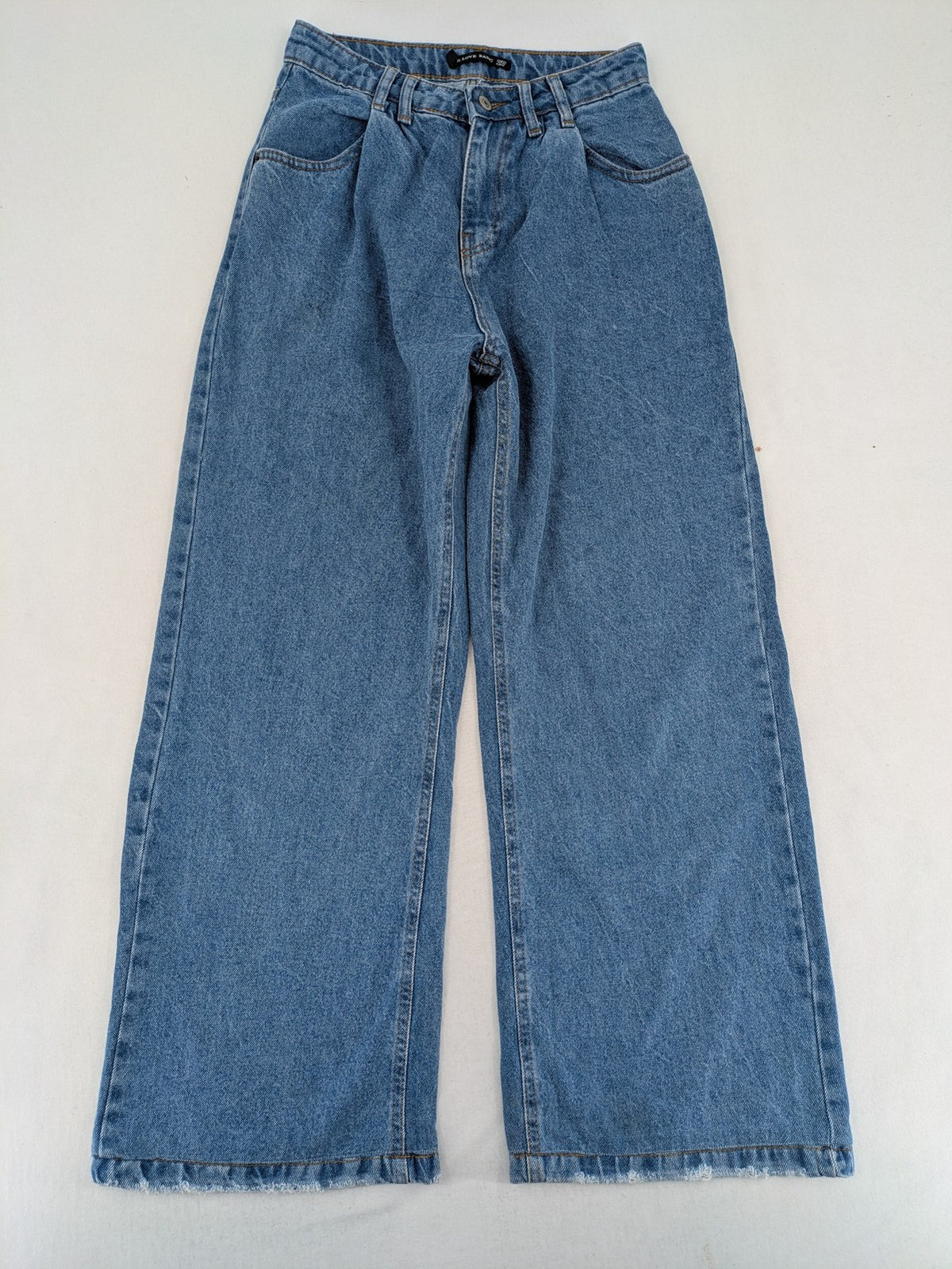 X.LOVE blue high waist wide leg jeans with front pleats and frayed hem.