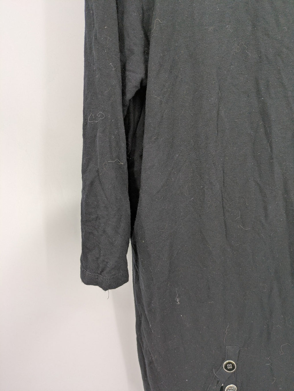Cupio black long sleeve tunic with side button placket and high-low hem.
