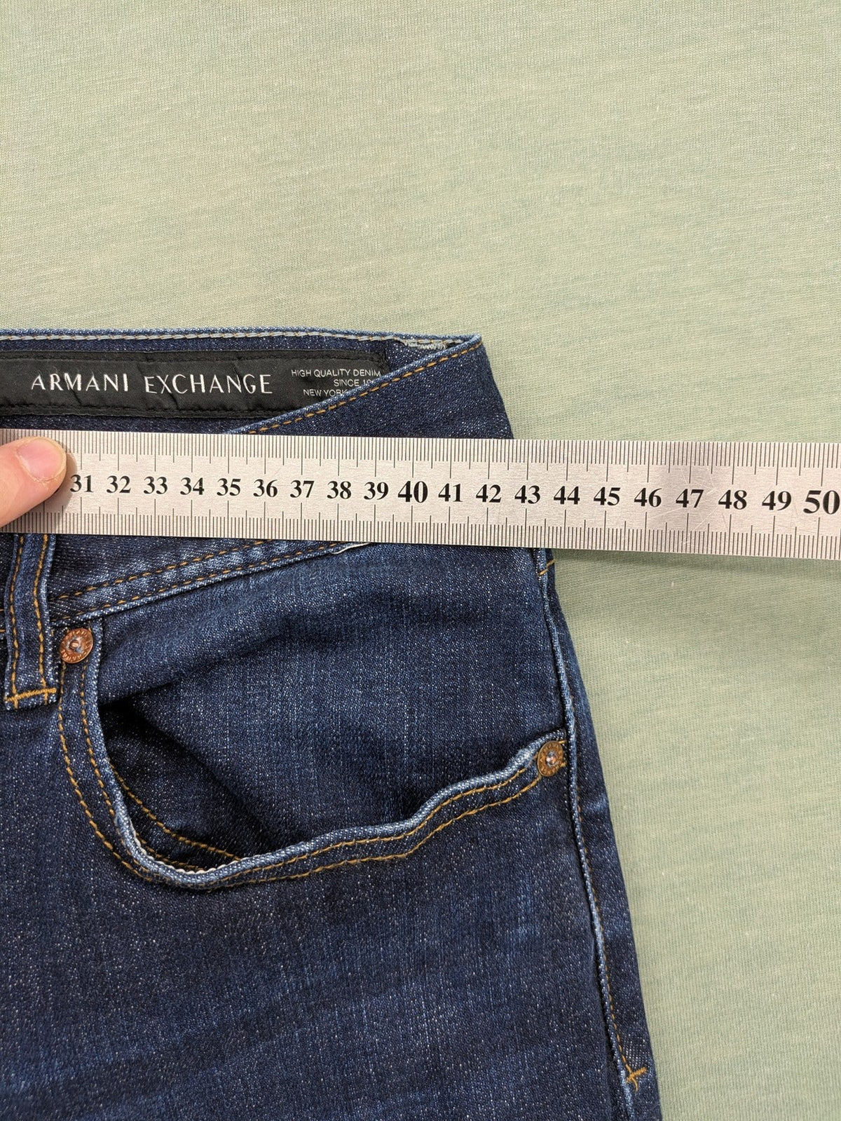 Armani Exchange blue slim fit jeans with distressed details and classic 5-pocket design.